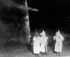 KKK clansmen burning a cross