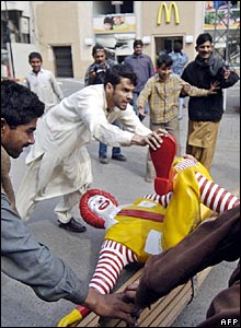 Muslim rioter knocks over Ronald McDonald statue