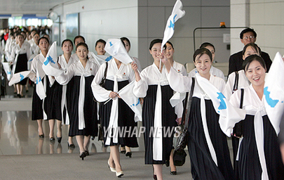 North Korean cheerleaders in white tops and black dresses