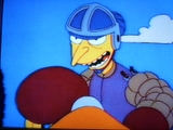 Mr. Burns in old-timey boxing clothing training a dog to attack
