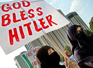 Muslim women in hijabs protesting with sign: God Bless Hitler