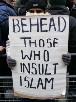 Muslim protesting with sign: Behead Those Who Insult Islam