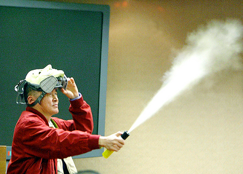 Legislator Lee Ao spraying can of tear gas in Taiwanese legislature