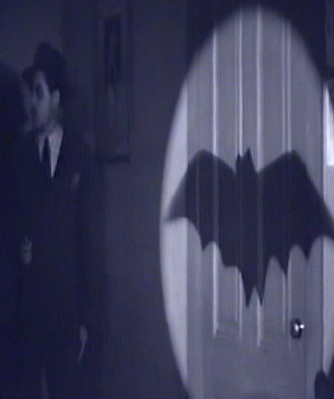 Bat signal projected onto a wall from an old Batman movie serial.