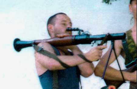 David Hicks with grenade or rocket launcher