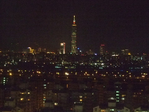 Taipei, Taiwan at night with Taipei 101 in the background. Taken from the Miramar Village Ferris wheel.