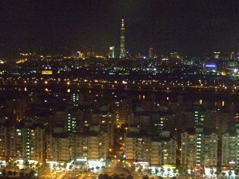 Taipei, Taiwan at night with Taipei 101 in the background. Taken from the Miramar Village Ferris wheel.