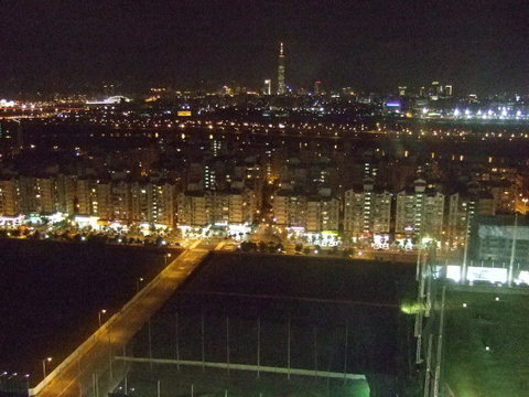 Taipei, Taiwan at night with Taipei 101 in the background. Taken from the Miramar Village Ferris wheel.