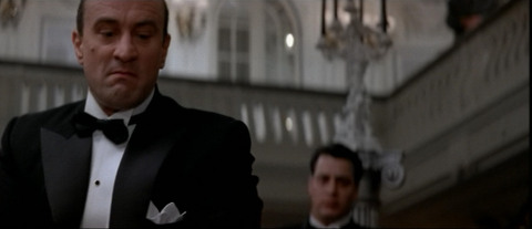 Al Capone (Robert de Niro) looks at the dead disloyal gangster who just killed with his baseball bat. From The Untouchables.