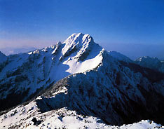 Jade Mountain in Taiwan, covered in snow against a pure blue sky.