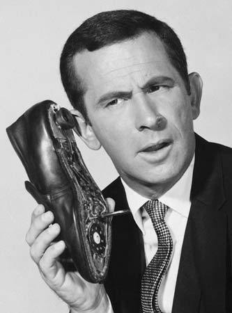 Maxwell Smart with his secret shoe phone. From the Get Smart! tv series.