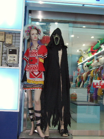 Women's aboriginal costume next to a Ghostface costume (from the movie, Scream).