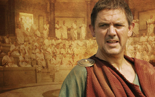 Marcus Tullius Cicero in front of a sepia painting of the Roman Senate. From HBO's Rome.