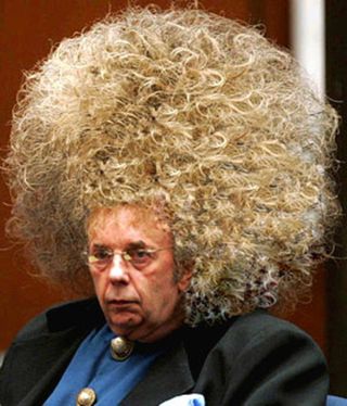 Music producer Phil Spector in court, arguing that he should be permitted to wear a giant wig in prison.