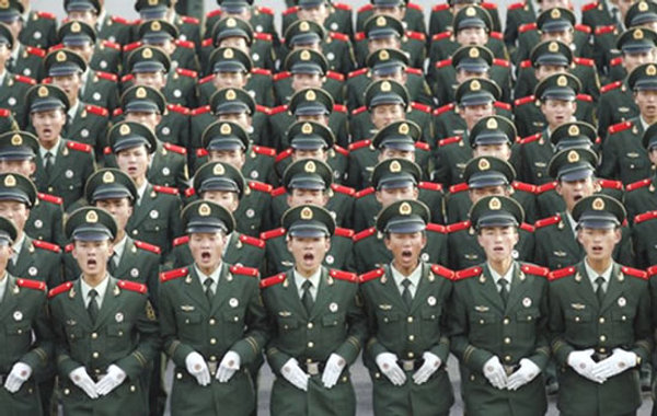 PLA soldiers in formation, each with needles in their collars.