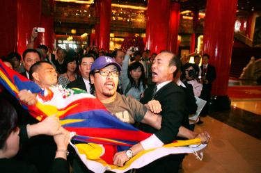Security at Taiwan's Grand Hotel seize Tibetan guest on behalf of Chinese Communist Party guests. Hotel security attempts to pull the Tibetan's flag from his hands.