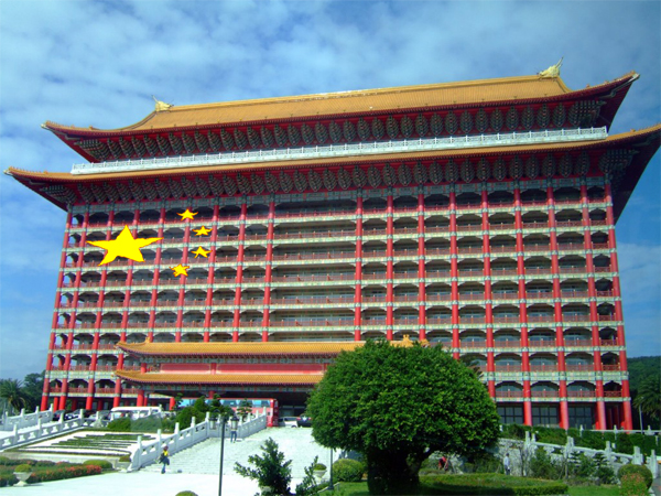 Taiwan's red and green Grand Hotel against a blue sky, with the stars of   Communist China's flag overlaid on the exterior.