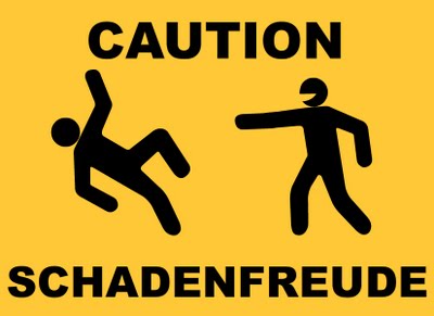 Yellow 'Caution: Schadenfreude' sign, depicting stick figure man slipping while another points and laughs.