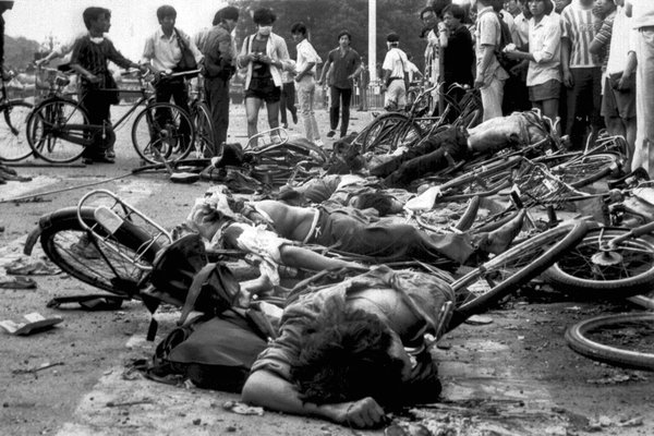 Black and white photo of Chinese next to their bicycles after being crushed by tanks at Tiananmen Square.
