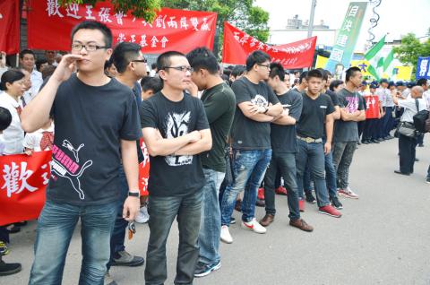 KMT President Ma Ying-jeou's mafia. Taiwanese mafia members wearing black shirts and pants stand waiting to beat Taiwanese protesting the visit of Chinese Communist Party negotiator Zhang Zhijun.
