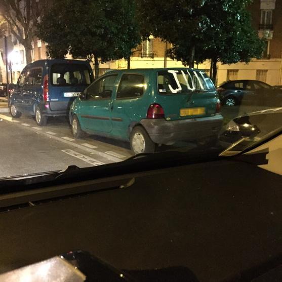 A Parisian car with the word, 'Juif' (Jew) spray-painted on the rear window.