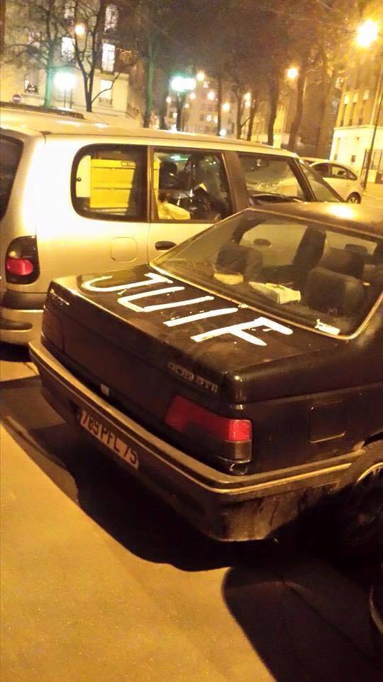 A Parisian car with the word, 'Juif' (Jew) spray-painted on the trunk.