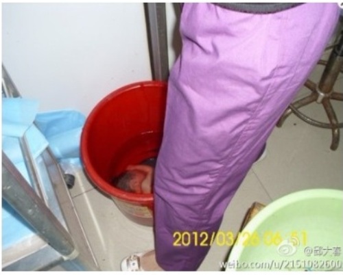 Chinese baby drowned in a red bucket by the Chinese Communist Party.